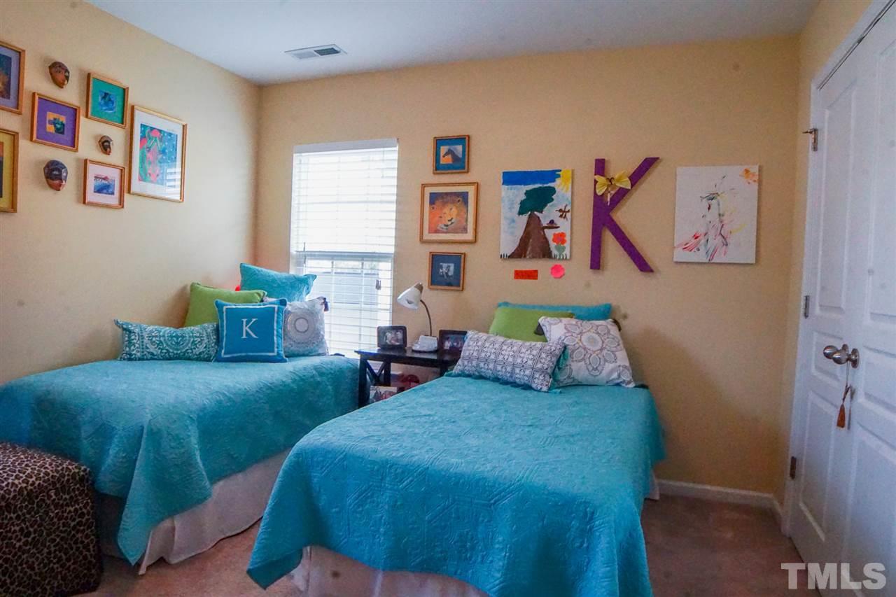 1023 Ileagnes Road Raleigh, NC 27603 - Photo 22 of 25 a bedroom with two beds and painting on the wall