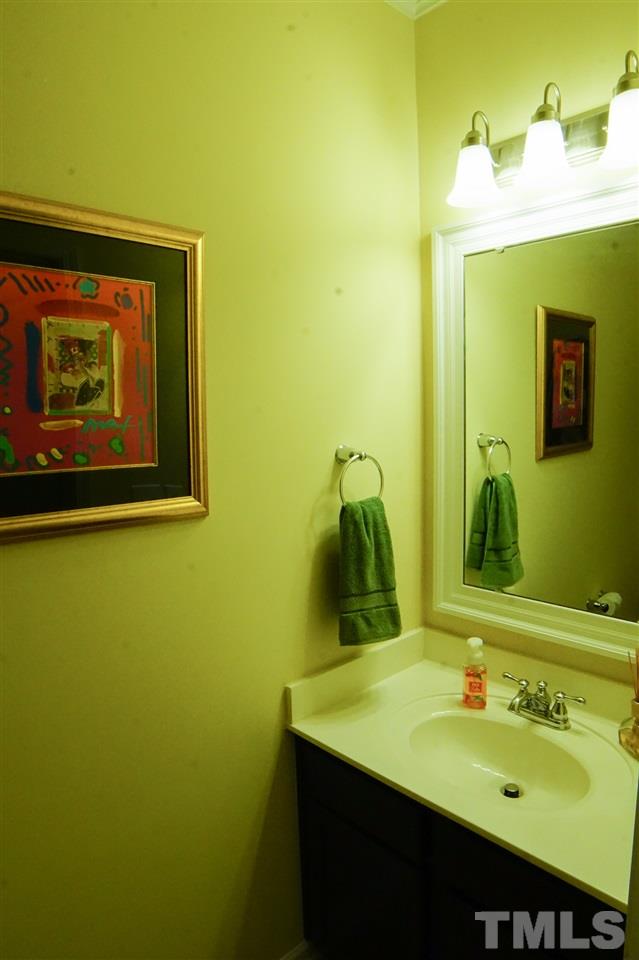 1023 Ileagnes Road Raleigh, NC 27603 - Photo 23 of 25 a bathroom with a sink and a mirror