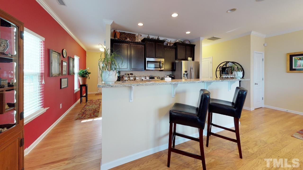 1023 Ileagnes Road Raleigh, NC 27603 - Photo 4 of 25 a view of a dining room with furniture and wooden floor