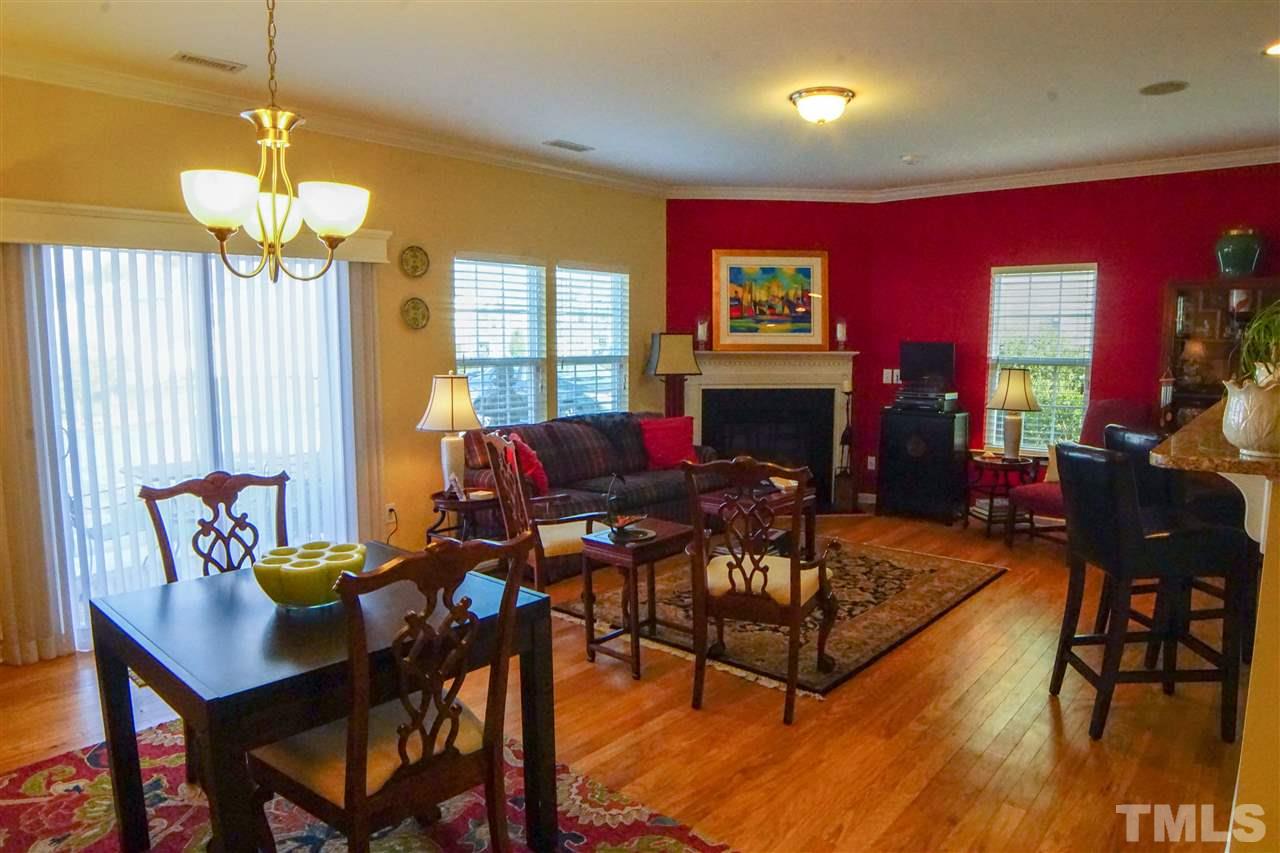 1023 Ileagnes Road Raleigh, NC 27603 - Photo 6 of 25 a living room with furniture a fireplace and a chandelier
