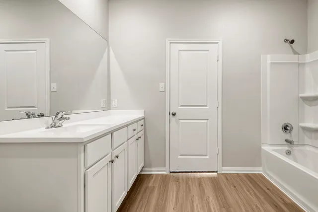 a bathroom with a sink a mirror and a bathtub