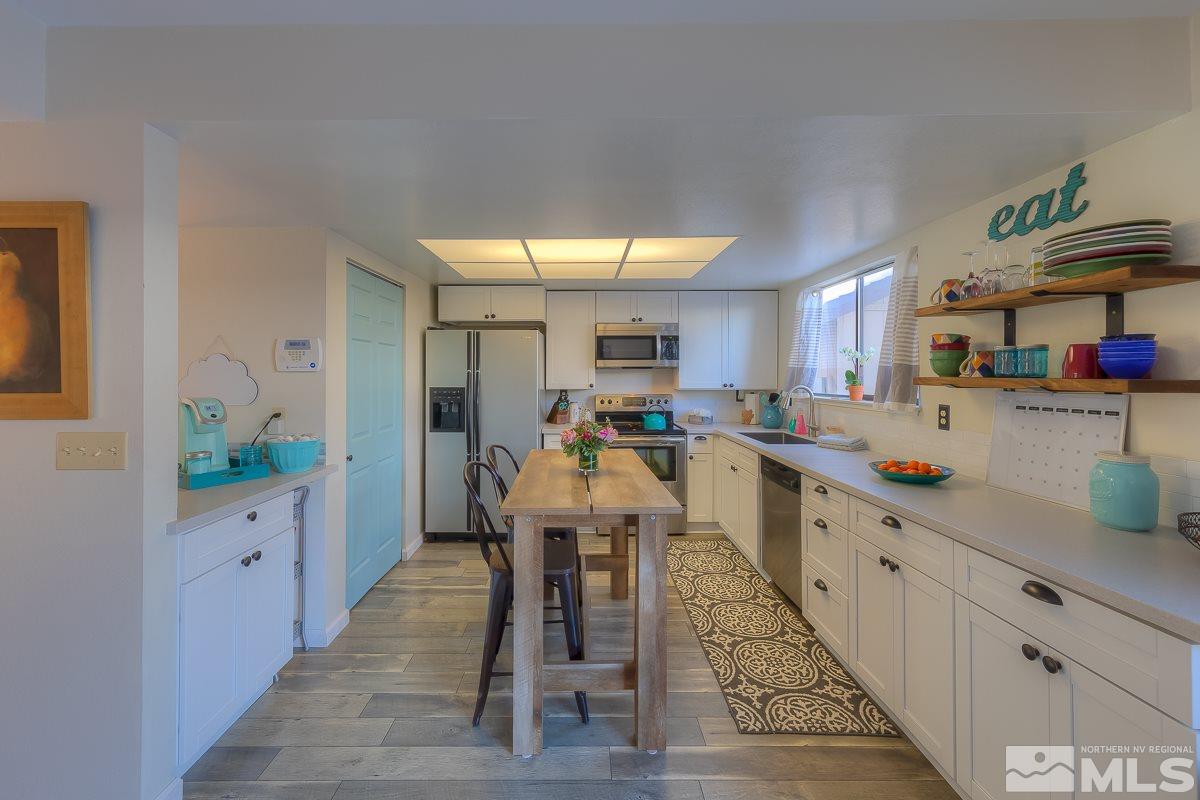 1499 Foster Drive Reno, NV 89509 - Photo 4 of 24 a kitchen with cabinets and window