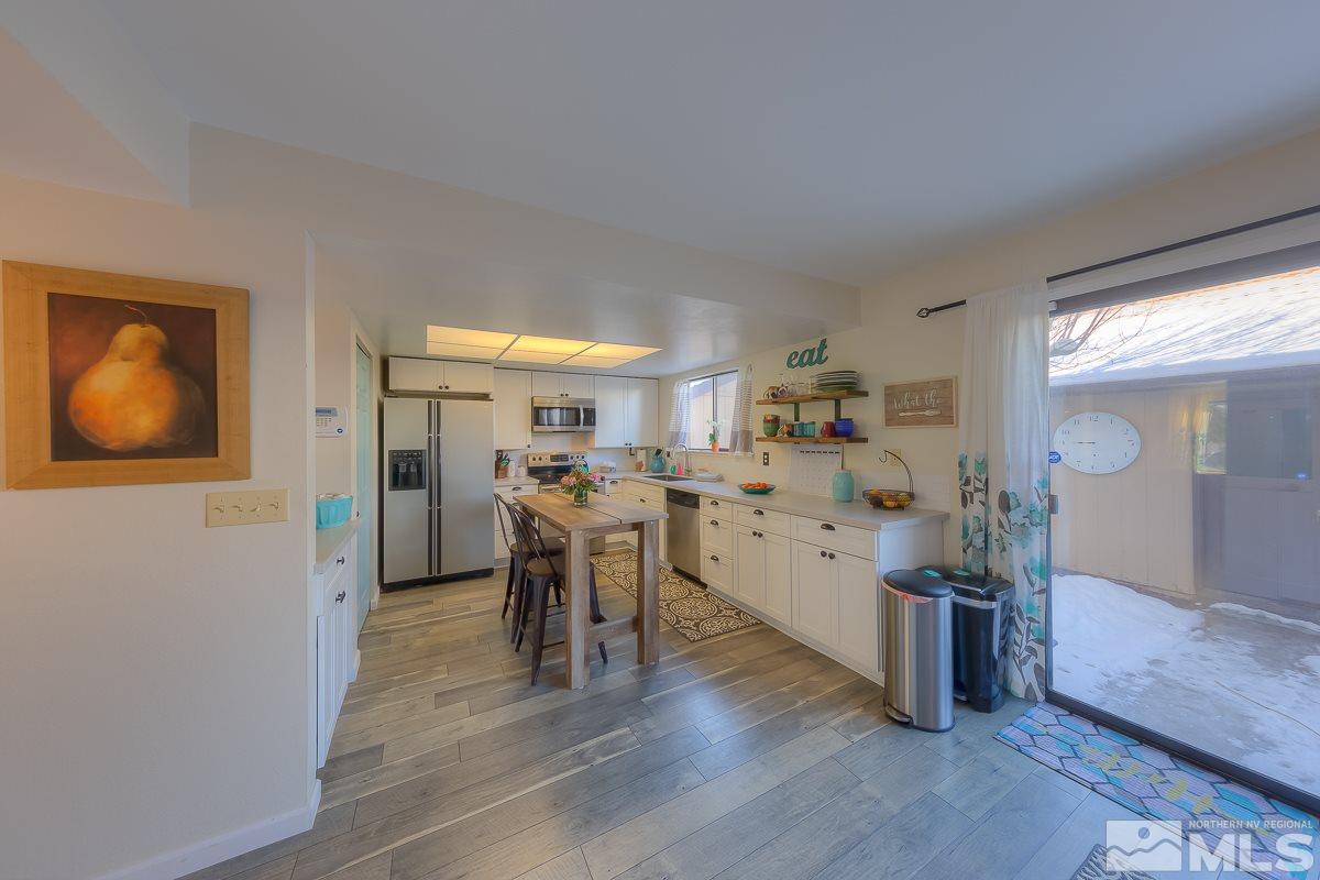 1499 Foster Drive Reno, NV 89509 - Photo 5 of 24 a view of a dining room with furniture and wooden floor