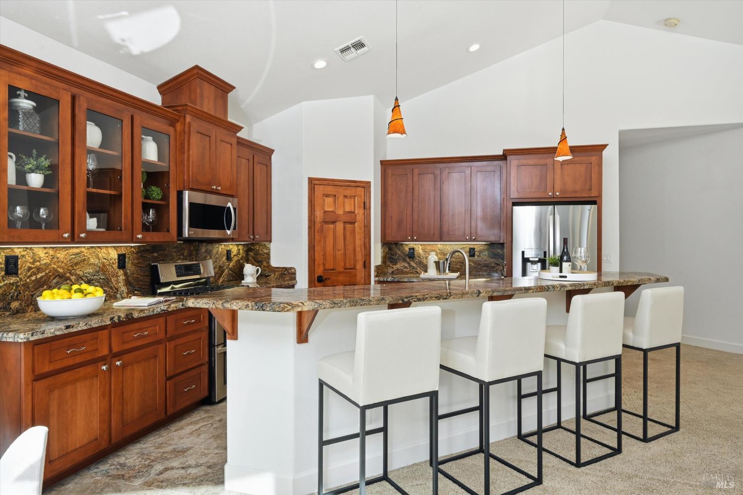 5251 Dry Creek Road Napa, CA 94558 - Photo 15 of 61 a kitchen with stainless steel appliances granite countertop a stove a sink dishwasher a dining table and chairs with wooden floor
