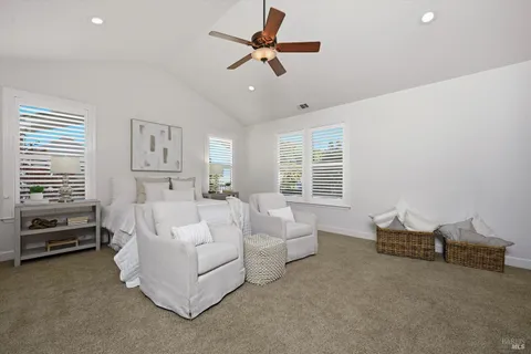a view of a room with window and a ceiling fan