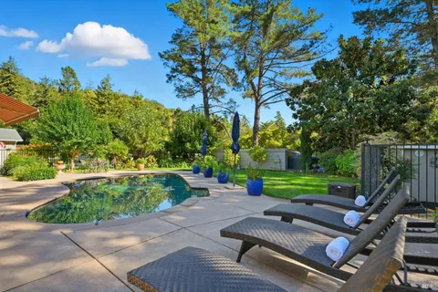 a view of a backyard with sitting area