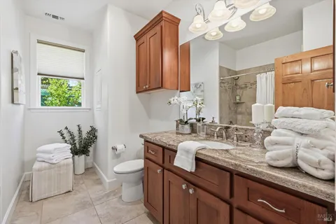a view of a patio with table and chairs potted plants and floor to ceiling window
