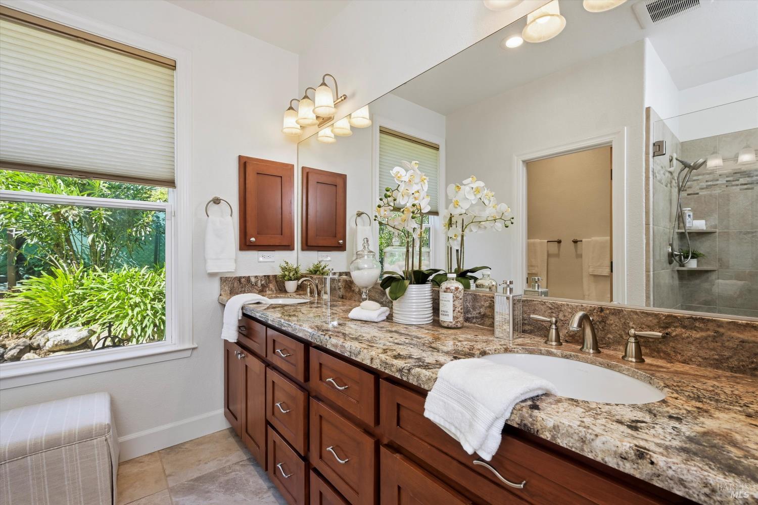 5251 Dry Creek Road Napa, CA 94558 - Photo 25 of 61 a bathroom with a granite countertop sink and a mirror