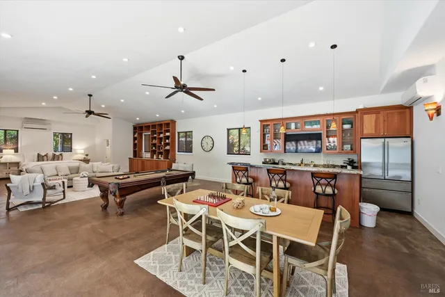 a living room with furniture pool table and window