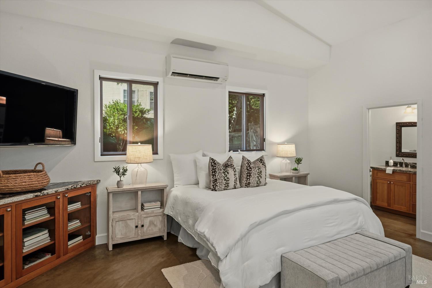 5251 Dry Creek Road Napa, CA 94558 - Photo 51 of 61 a bedroom with a bed and a flat screen tv