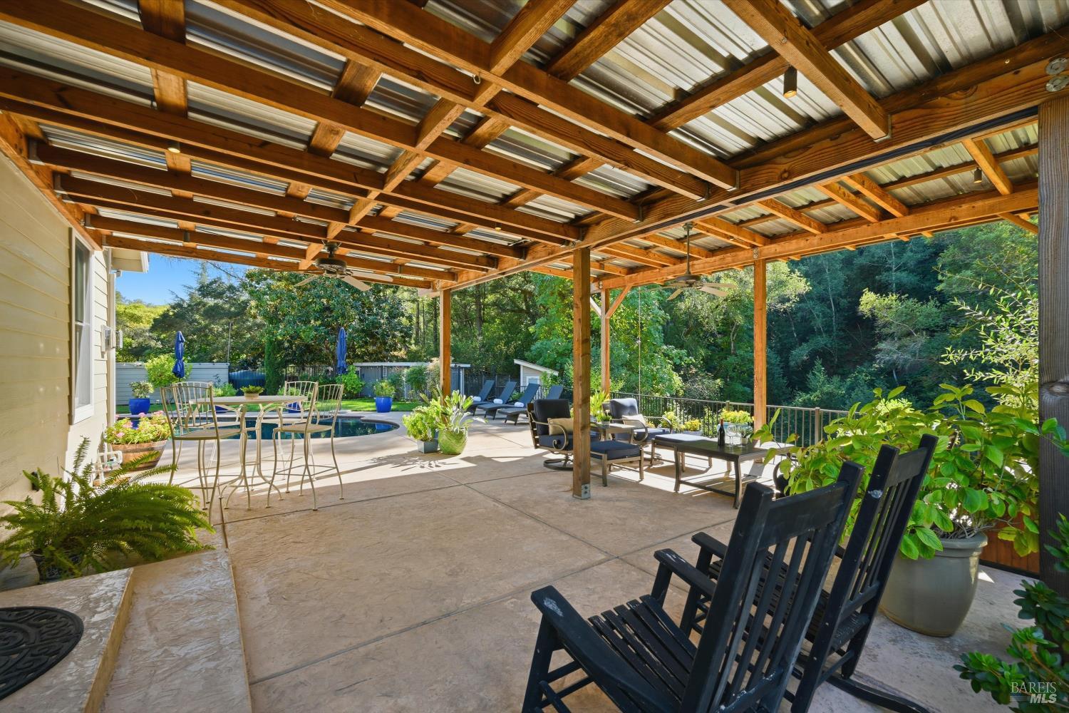 5251 Dry Creek Road Napa, CA 94558 - Photo 10 of 61 a view of a patio with table and chairs potted plants and floor to ceiling window