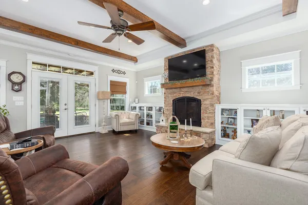 a living room with fireplace furniture and a flat screen tv
