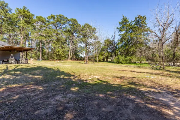 a view of yard with tree in the background