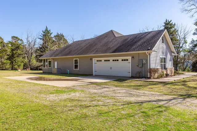 a house view with swimming pool in front of it