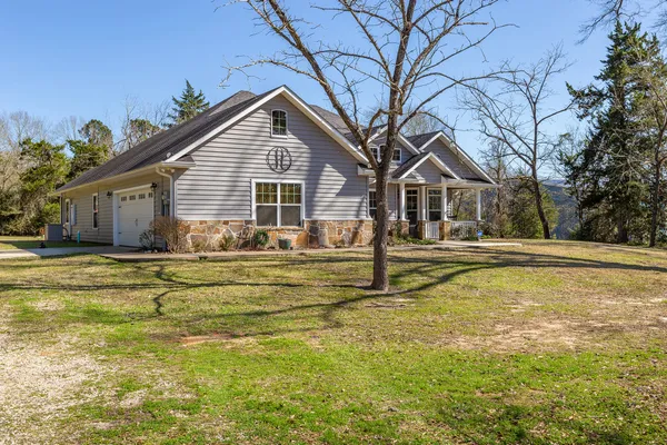 a view of pool of water with yard and trees around