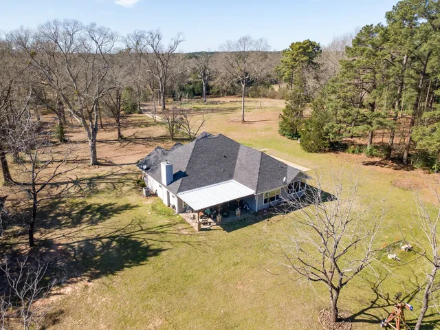 a view of a swimming pool with a yard
