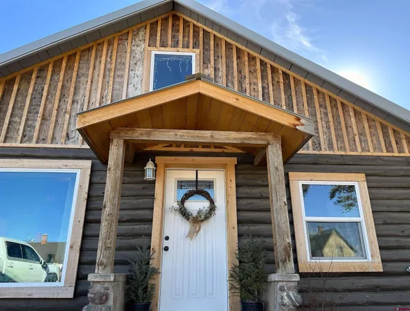 a front view of a house with plants