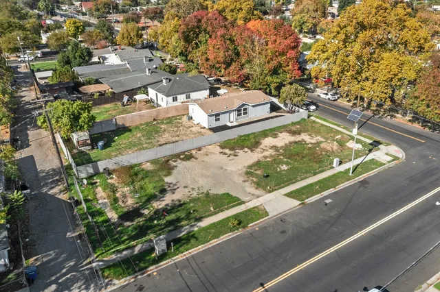 an aerial view of a residential houses with outdoor space