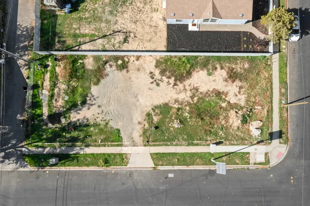 an aerial view of a house with a yard and lake view