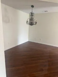 a view of empty room with wooden floor and fireplace