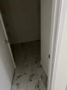 a bathroom with a toilet and a rug