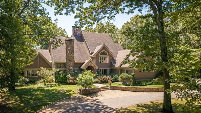 a front view of house with yard and green space