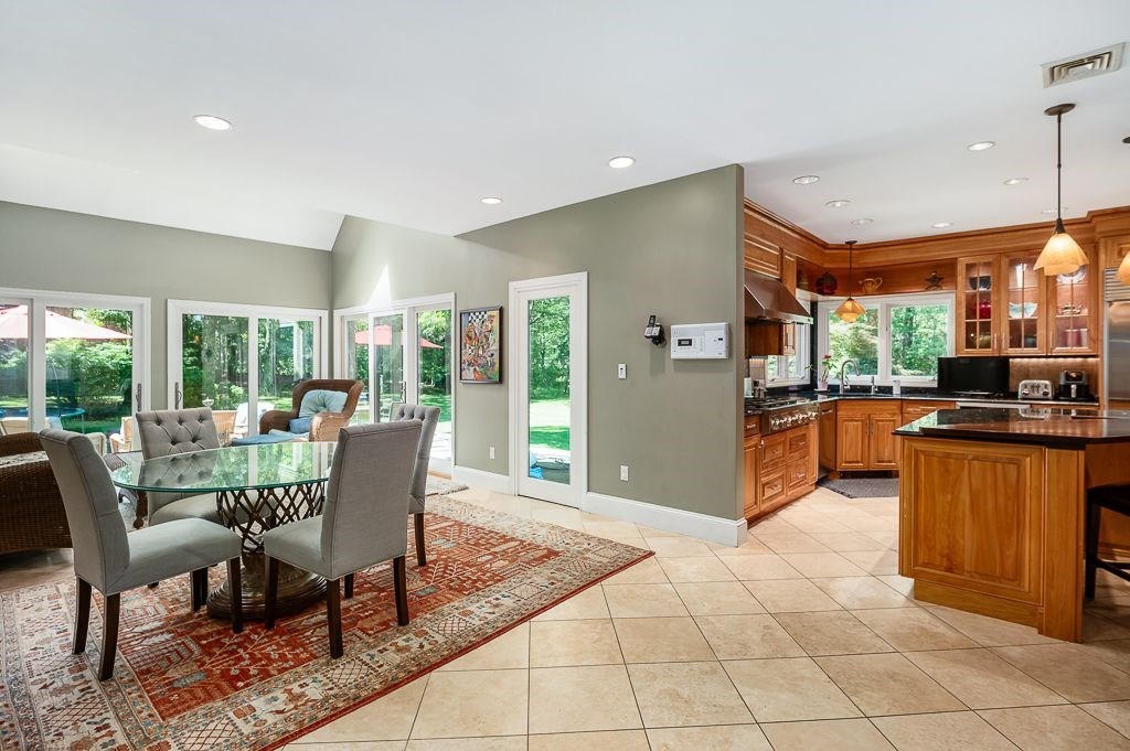 30 Autumn Lane Hamilton, MA 01982 - Photo 11 of 42 a view of a dining room and livingroom with furniture large windows
