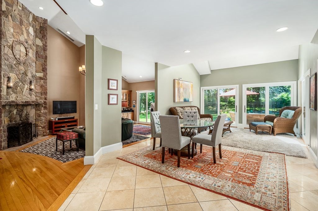 30 Autumn Lane Hamilton, MA 01982 - Photo 12 of 42 a living room with furniture a fireplace and a floor to ceiling window