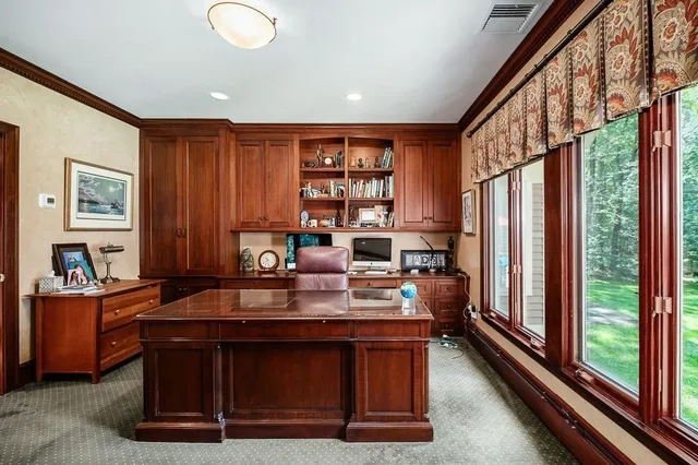 a dining room with furniture and a window