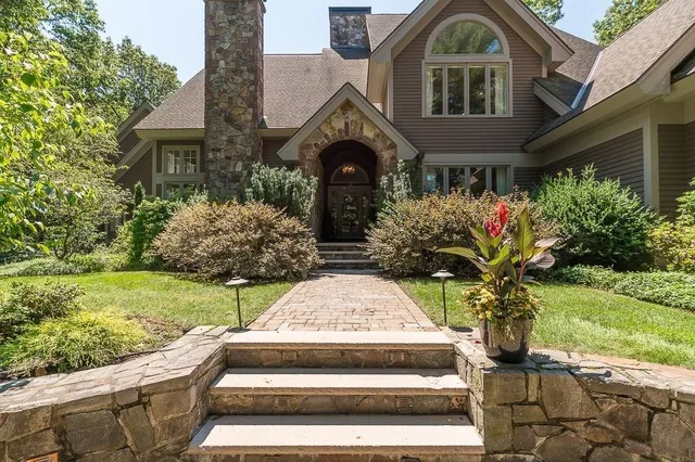 a front view of a house with garden