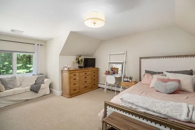 a bedroom with furniture and flat screen tv