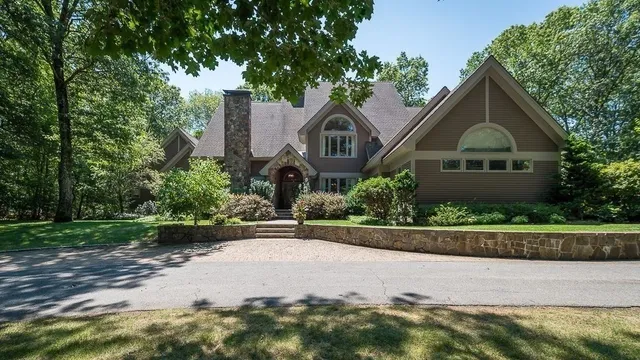 a front view of a house with a garden