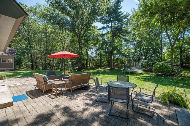 a backyard of a house with outdoor seating