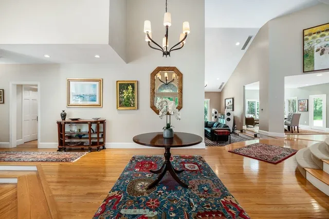 a living room with fireplace furniture and a chandelier