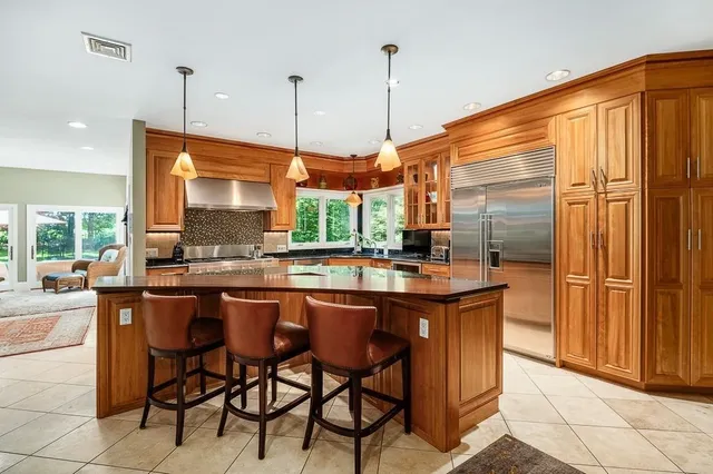a kitchen with stainless steel appliances granite countertop a stove and refrigerator