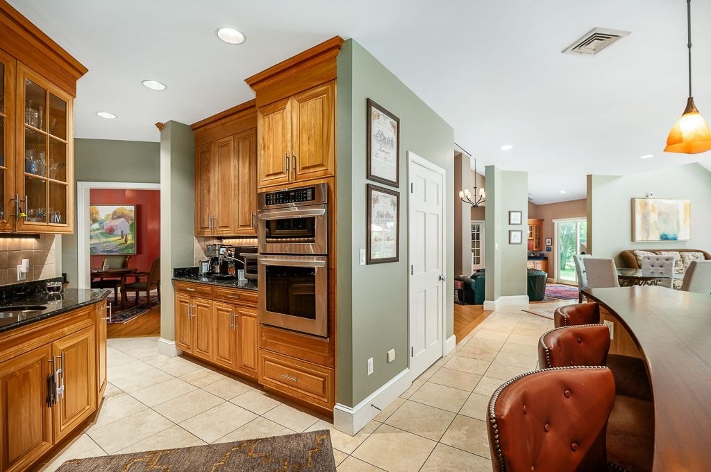 30 Autumn Lane Hamilton, MA 01982 - Photo 10 of 42 a living room with stainless steel appliances furniture a flat screen tv and kitchen view