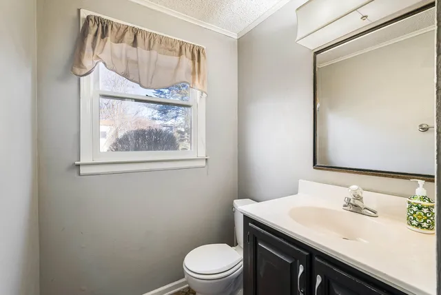 an empty room with a fireplace and a window