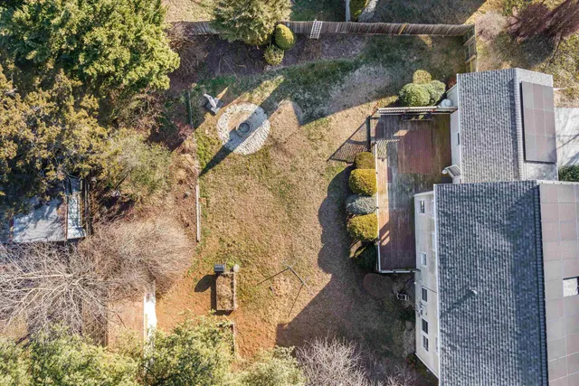 a bedroom with a large bed and a potted plant