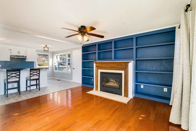 a living room with a fireplace and a walk in closet