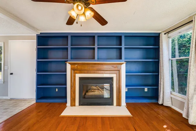 a kitchen with a refrigerator a stove a sink dishwasher and white cabinets with wooden floor