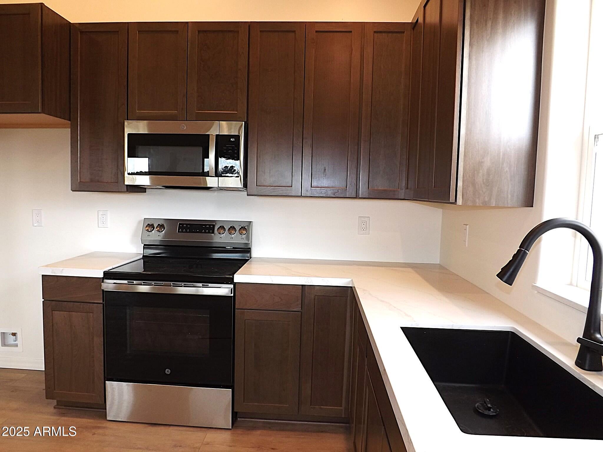 2763 Sunflower Drive Overgaard, AZ 85933 - Photo 18 of 18 a kitchen with a sink and cabinets