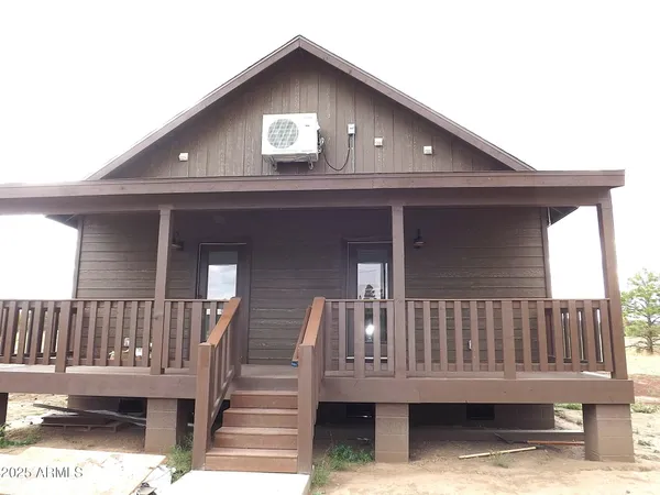 a kitchen with kitchen island granite countertop a sink dishwasher stove and cabinets with wooden floor