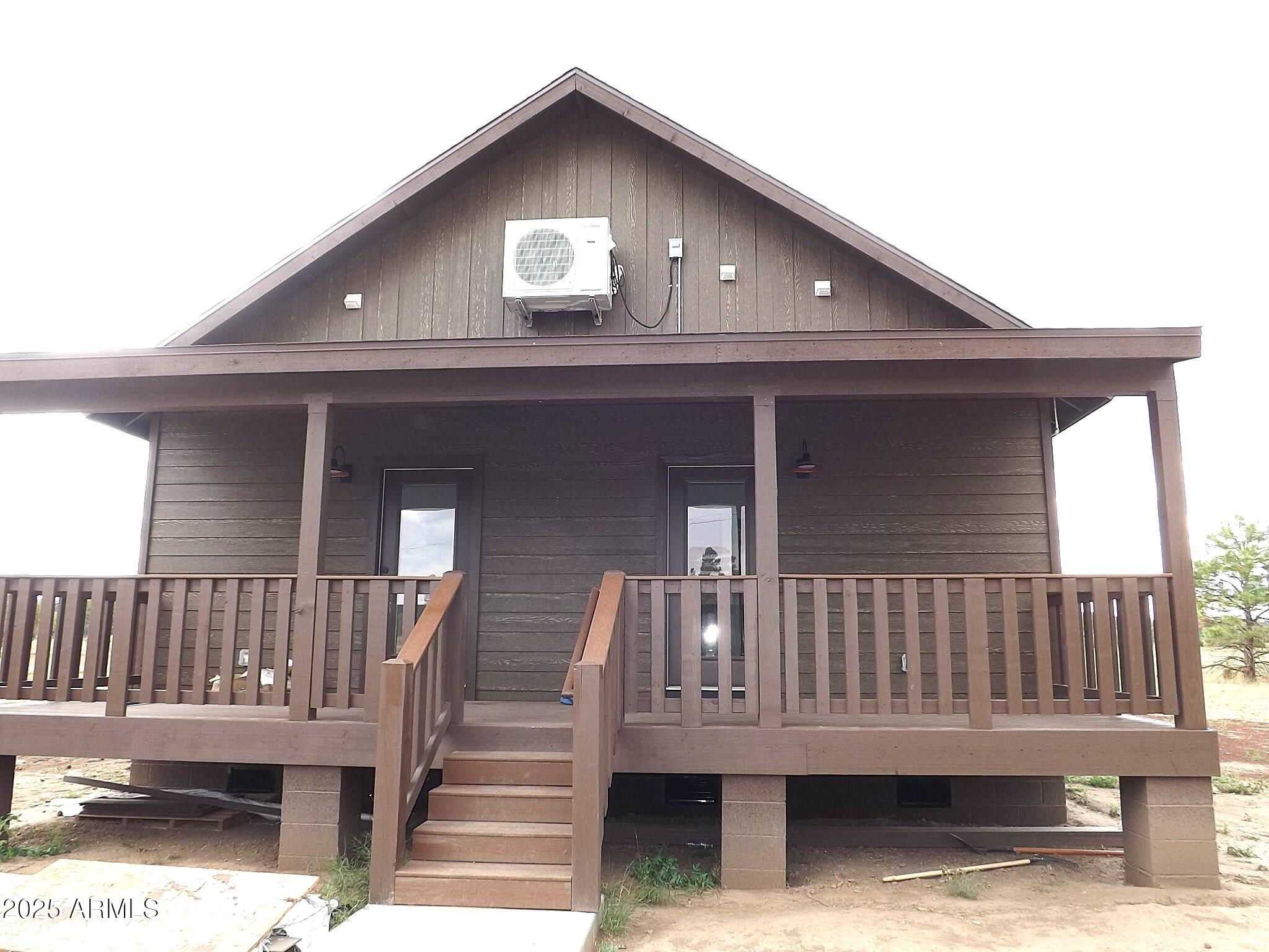 2763 Sunflower Drive Overgaard, AZ 85933 - Photo 5 of 18 a view of wooden house with a small deck