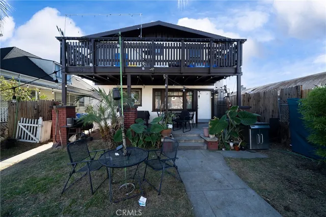 a view of a chair and table in backyard