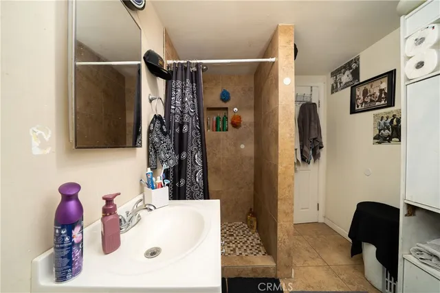 a bathroom with a sink vanity and shower