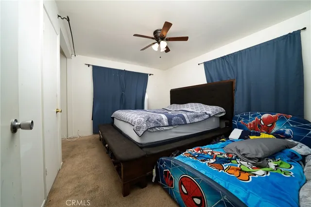 a bedroom with bed and a chandelier