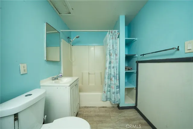 a bathroom with a toilet a sink and shower