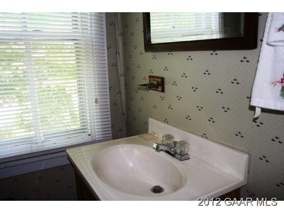 4966 Maple Sugar Road Blue Grass, VA 24413 - Photo 16 of 22 a bathroom with a sink a mirror and a shower