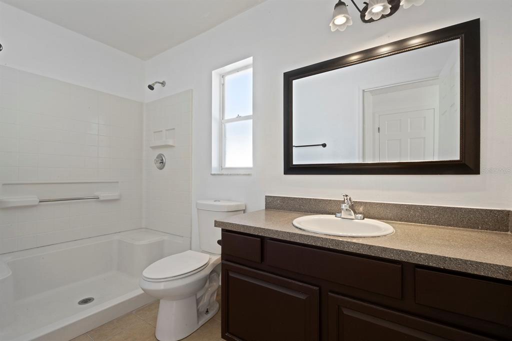 1533 Sunset View Circle Apopka, FL 32703 - Photo 15 of 23 a bathroom with a toilet sink double vanity and mirror