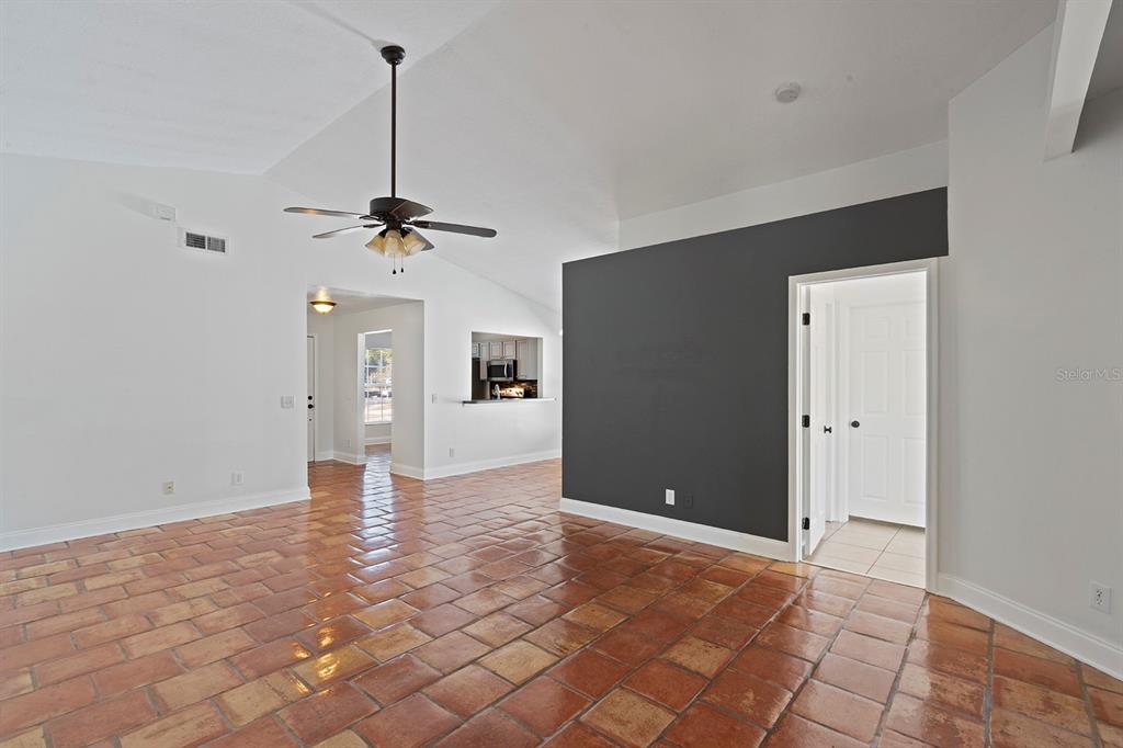 1533 Sunset View Circle Apopka, FL 32703 - Photo 5 of 23 a view of a big room with a chandelier fan and windows